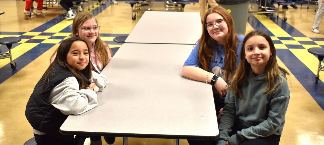students seated at cafeteria table